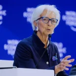 Christine Lagarde, President of the European Central Bank, speaking at a microphone during a World Economic Forum panel in Davos, Switzerland